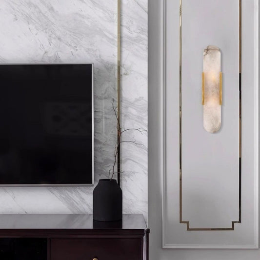 Brass alabaster wall light in bedroom setting