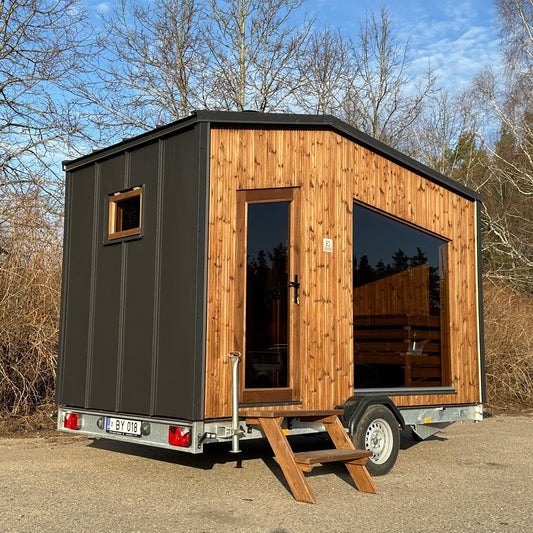 Side profile of the Nomad mobile sauna on its trailer
