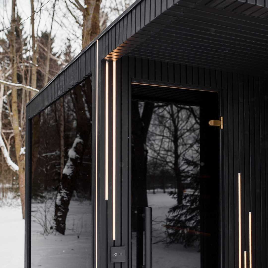 EBON outdoor sauna interior looking toward the black glass door