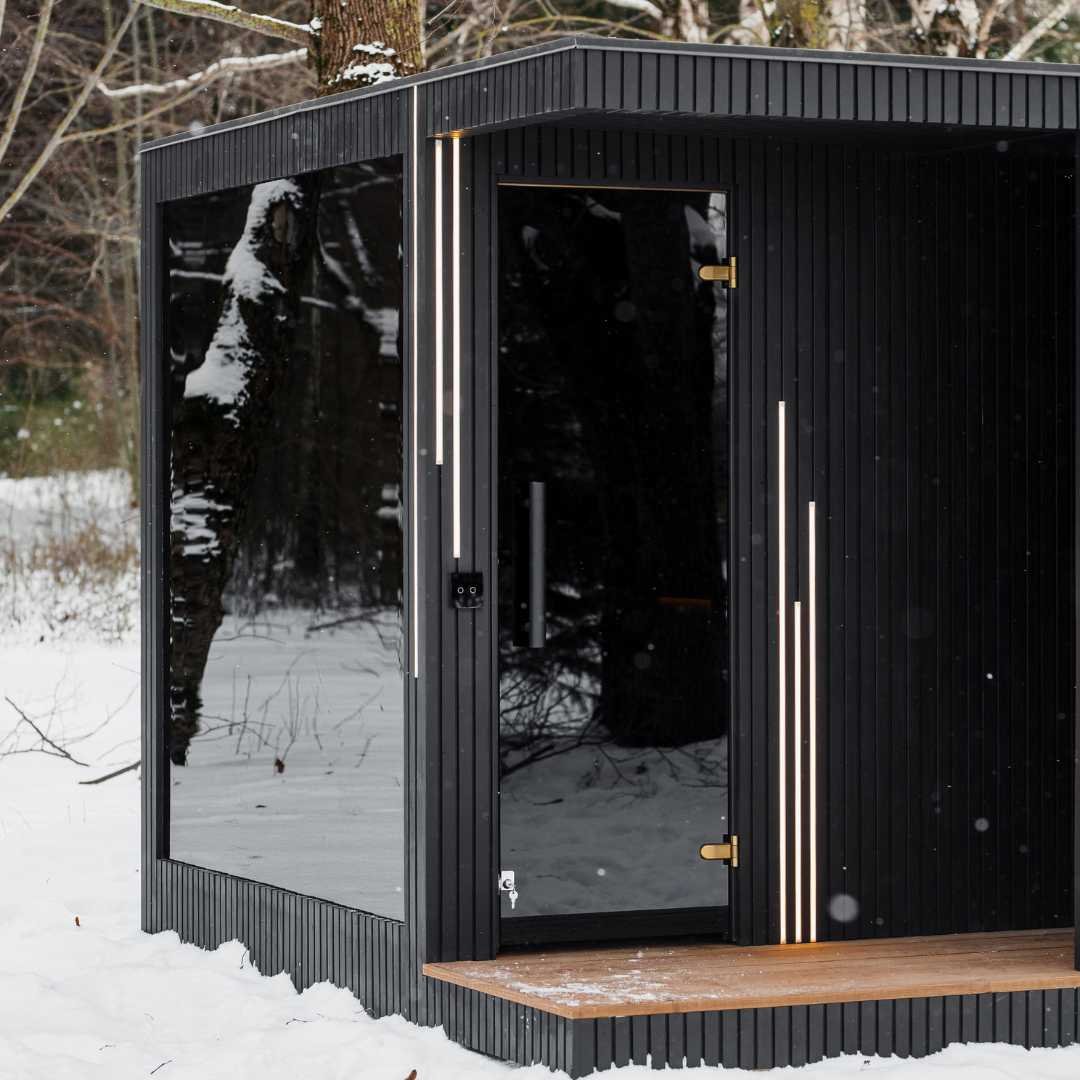 Integrated RAVAK shower area in black finish inside the EBON outdoor sauna