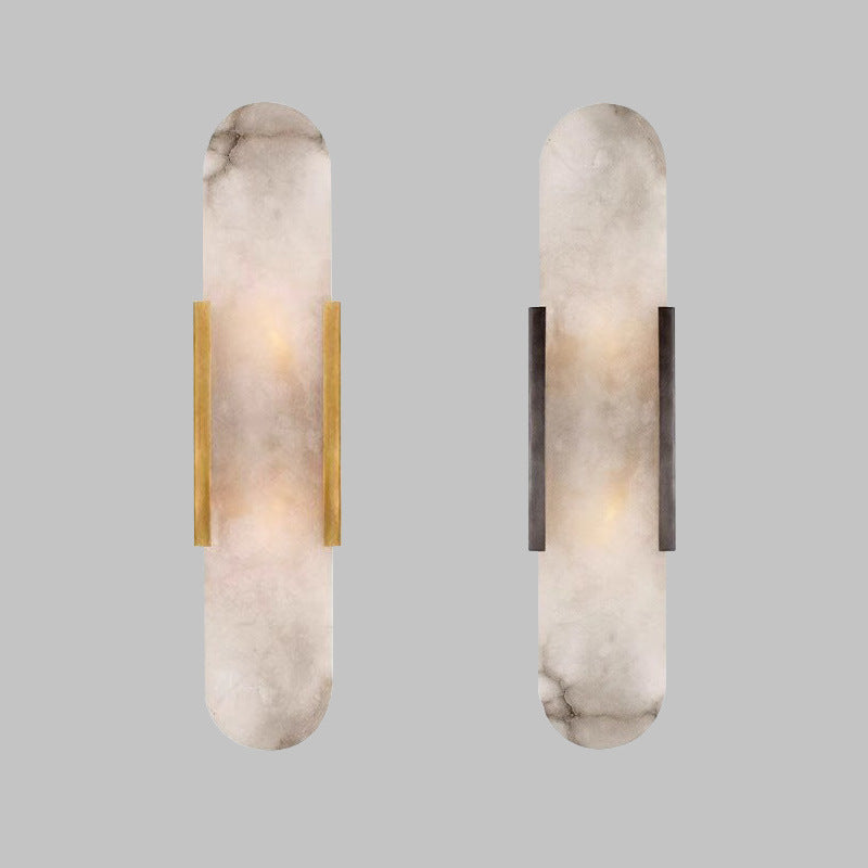 Natural alabaster block wall light warm brass frame glowing warm white