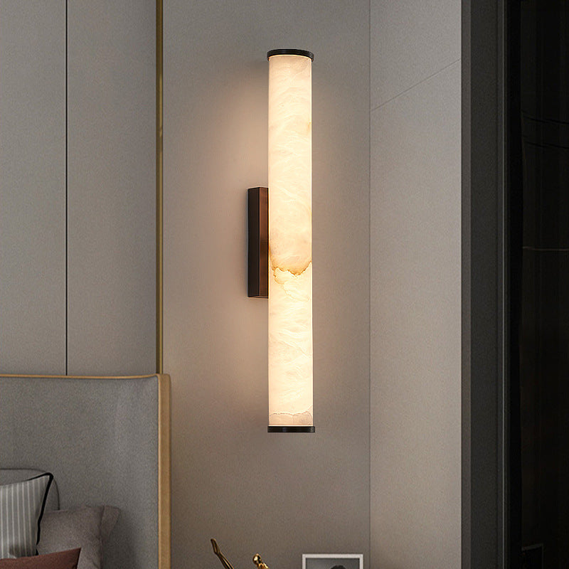 Slim recessed linear wall light with natural stone shade glowing warm white beside wardrobe
