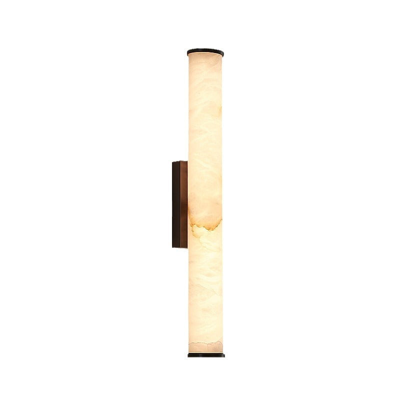 Slim stone-shade wall light casting soft glow in hallway