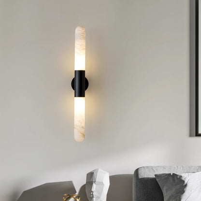 Brass alabaster wall sconce lit warm white hotel