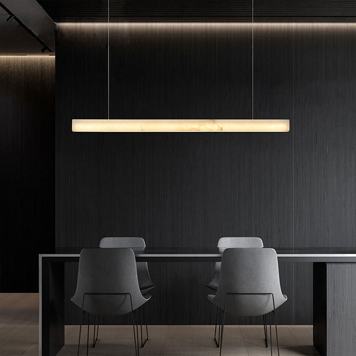 Minimalist stone linear pendant over kitchen island