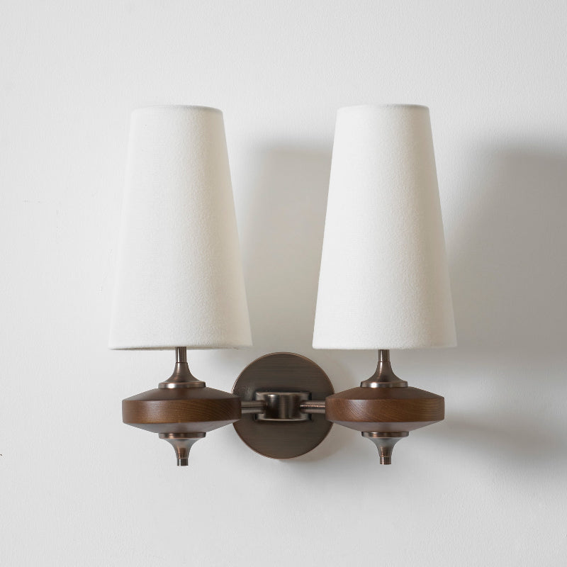 Double walnut and brass wall sconce with white linen shade