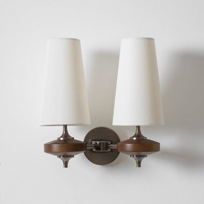 Double walnut and brass wall sconce with white linen shade