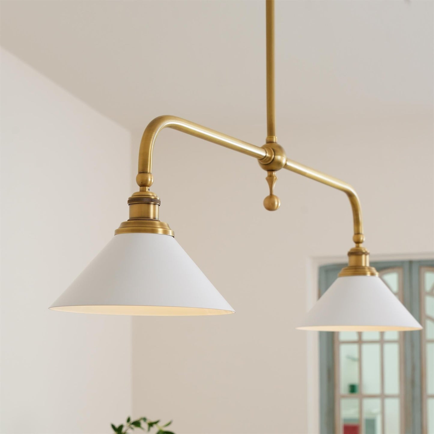 Hartwell brass two head pendant light over a kitchen island