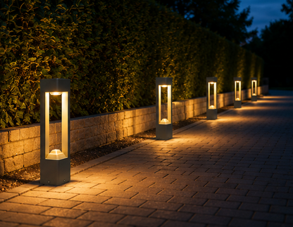 Garden bollard lights lining a driveway edge in the evening