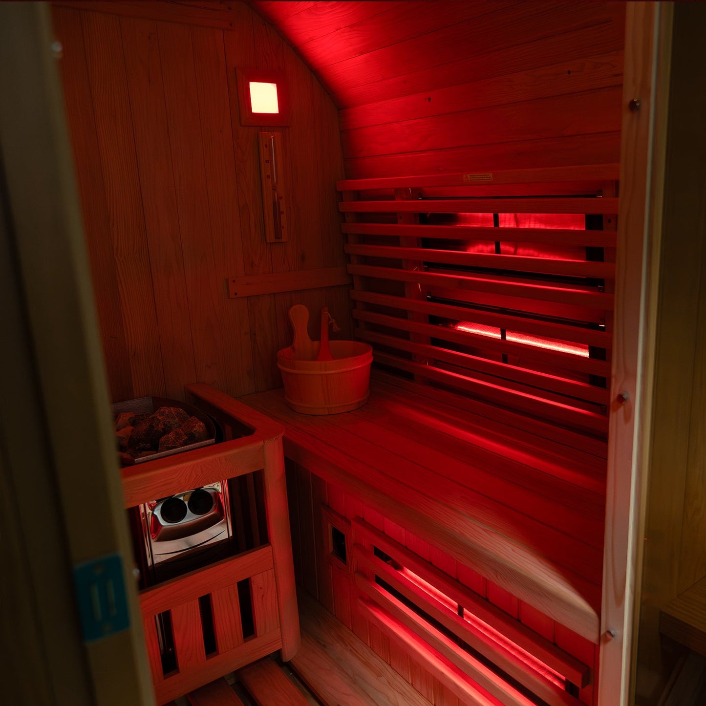 Interior of the Insignia Hybrid Barrel Sauna showing hemlock benches and infrared emitters