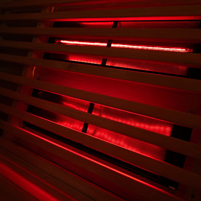 Red glass infrared emitter panel mounted in the barrel sauna wall