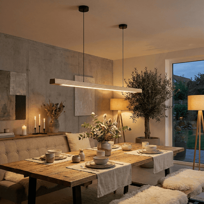 Walnut linear LED pendant light hanging above dining table, warm glow