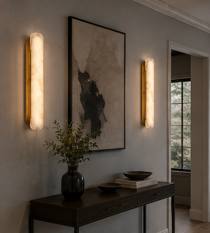Oval alabaster wall light mounted beside a bed as a bedside reading light