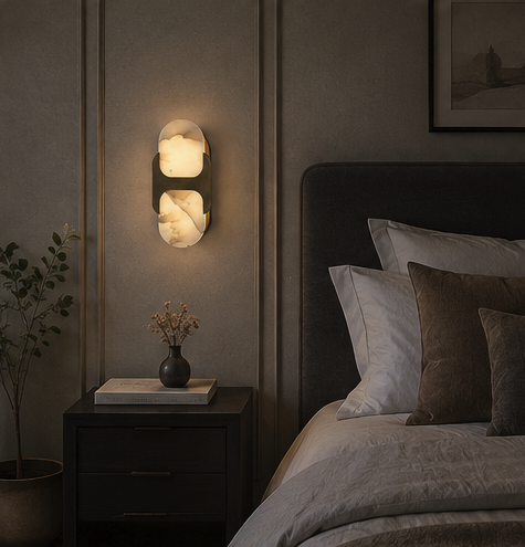 Pair of Ovale alabaster wall sconces mounted symmetrically on a plaster wall