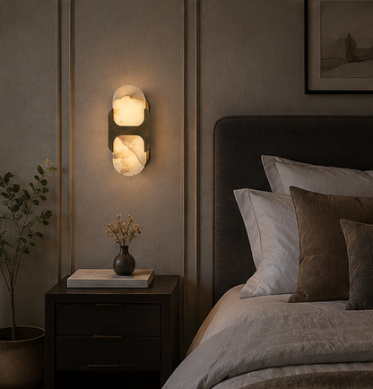 Pair of Ovale alabaster wall sconces mounted symmetrically on a plaster wall