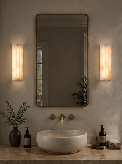 Puro cylindrical alabaster wall light showing the natural stone veining when lit